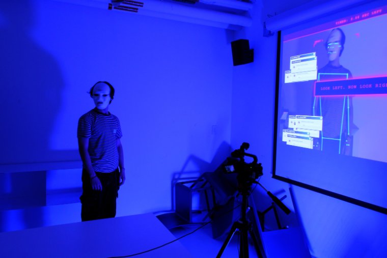 Participant in the blue-lit installation room