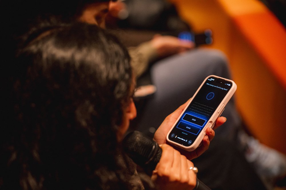 Audience member recording a memory on their phone